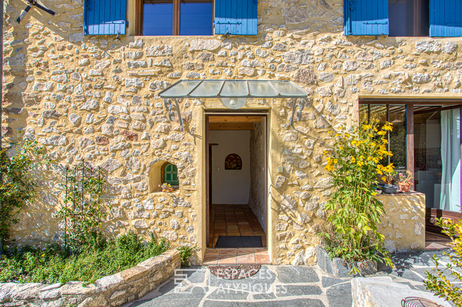 Two stone houses in an olive grove