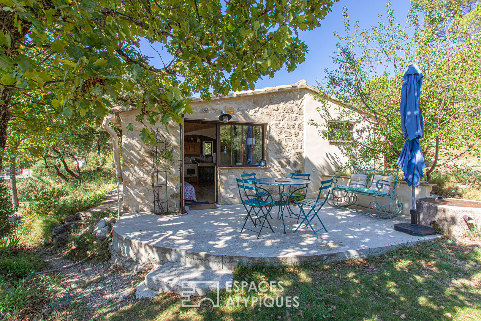 Two stone houses in an olive grove