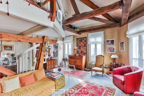 Duplex with exposed beams on the top floor