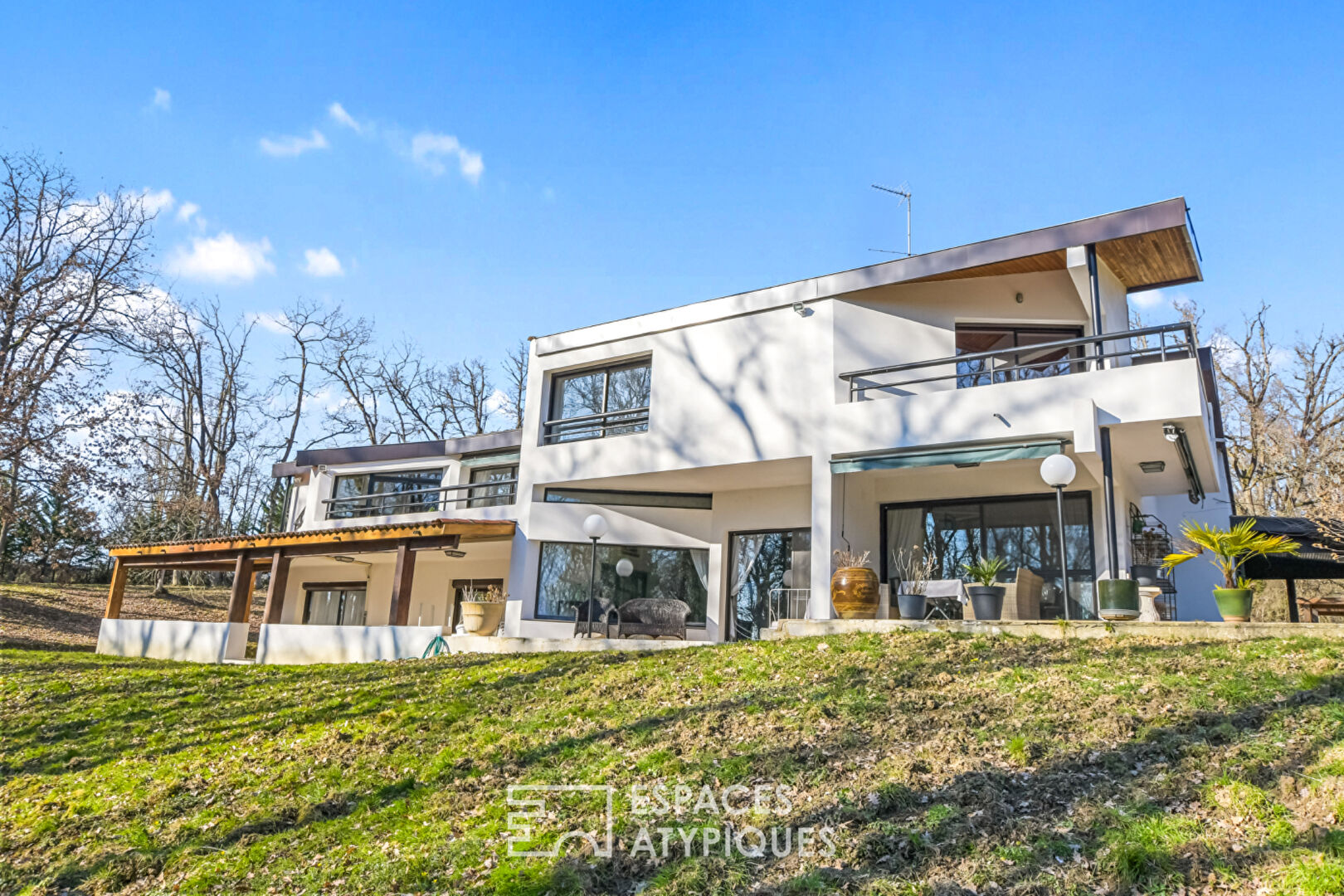 Architect-designed house and its park with woods