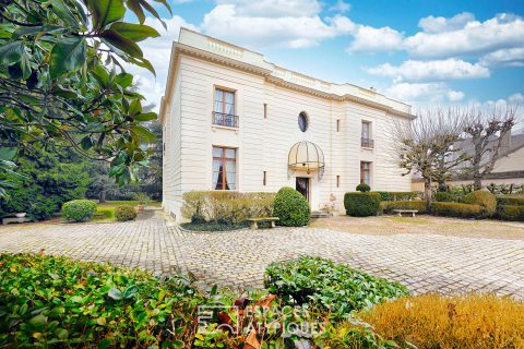 Art Deco style mansion with outbuildings and park