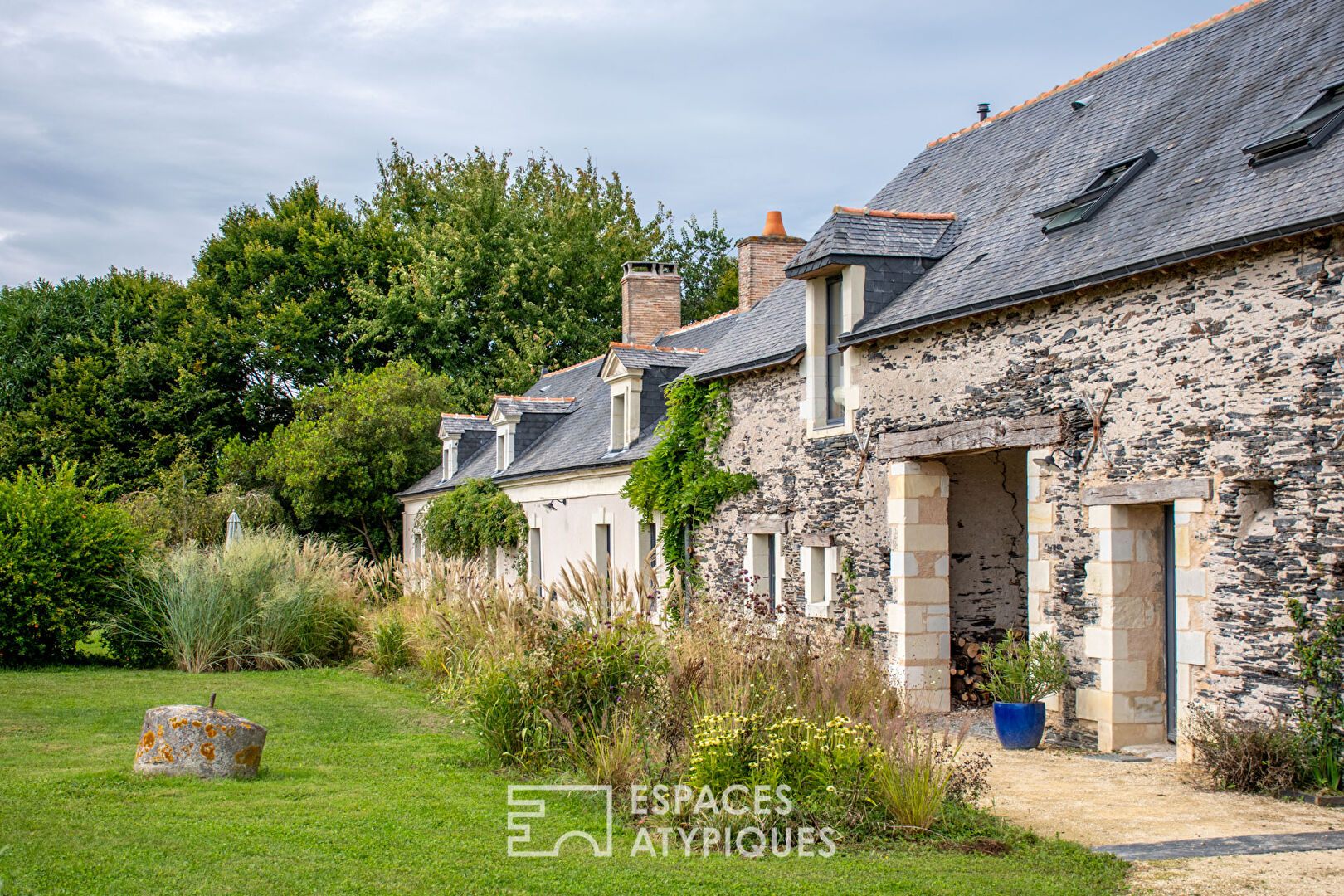 Renovated farmhouse in a green setting.