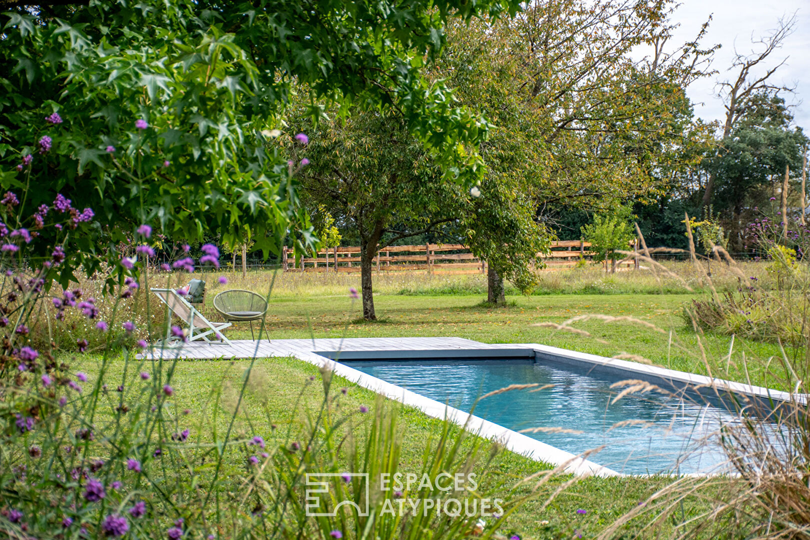 Renovated farmhouse in a green setting.