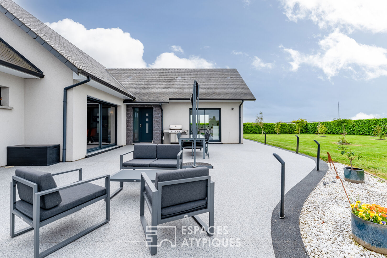 Contemporary family room on landscaped garden
