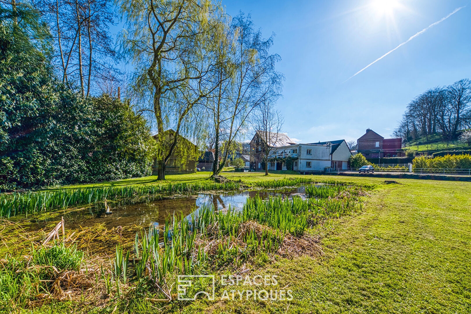 Former water mill turned real estate complex with garden and outbuilding