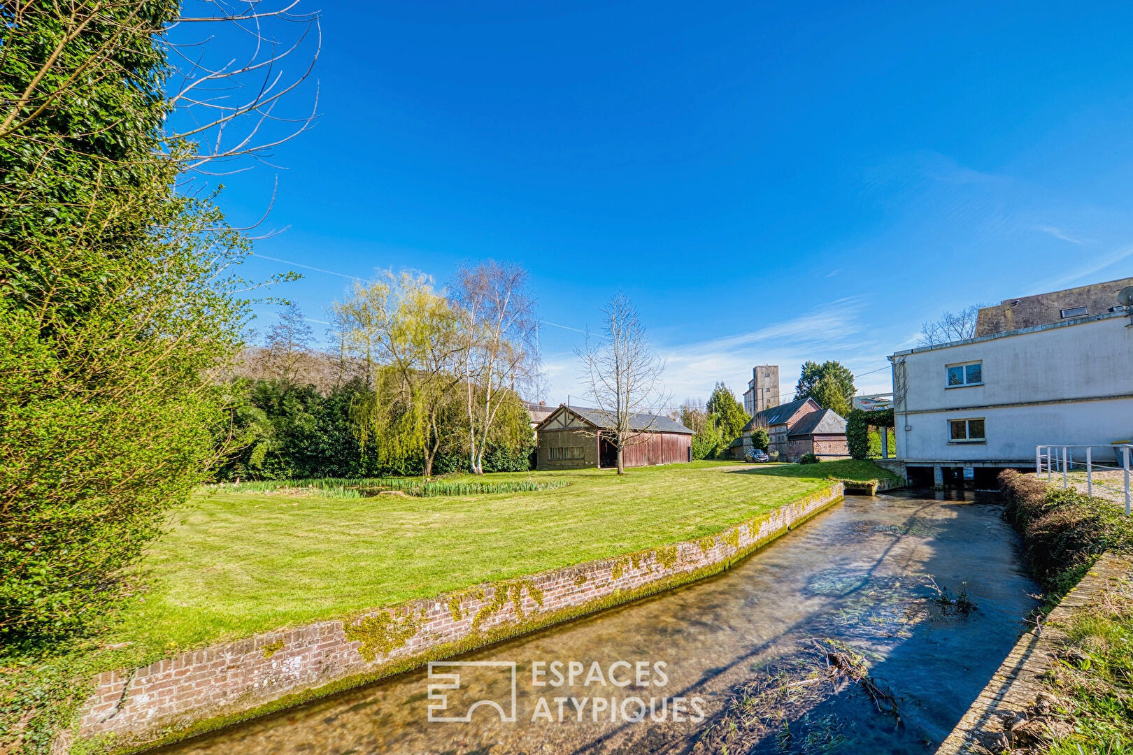 Former water mill turned real estate complex with garden and outbuilding