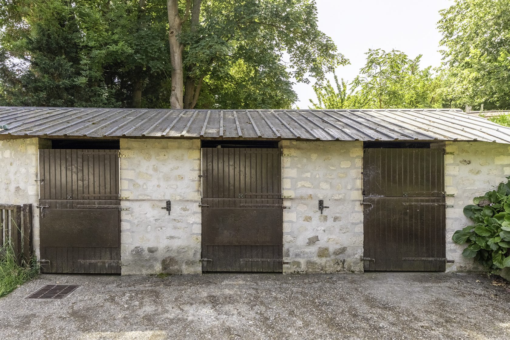 Former tack room converted into a dwelling and its three horse boxes.