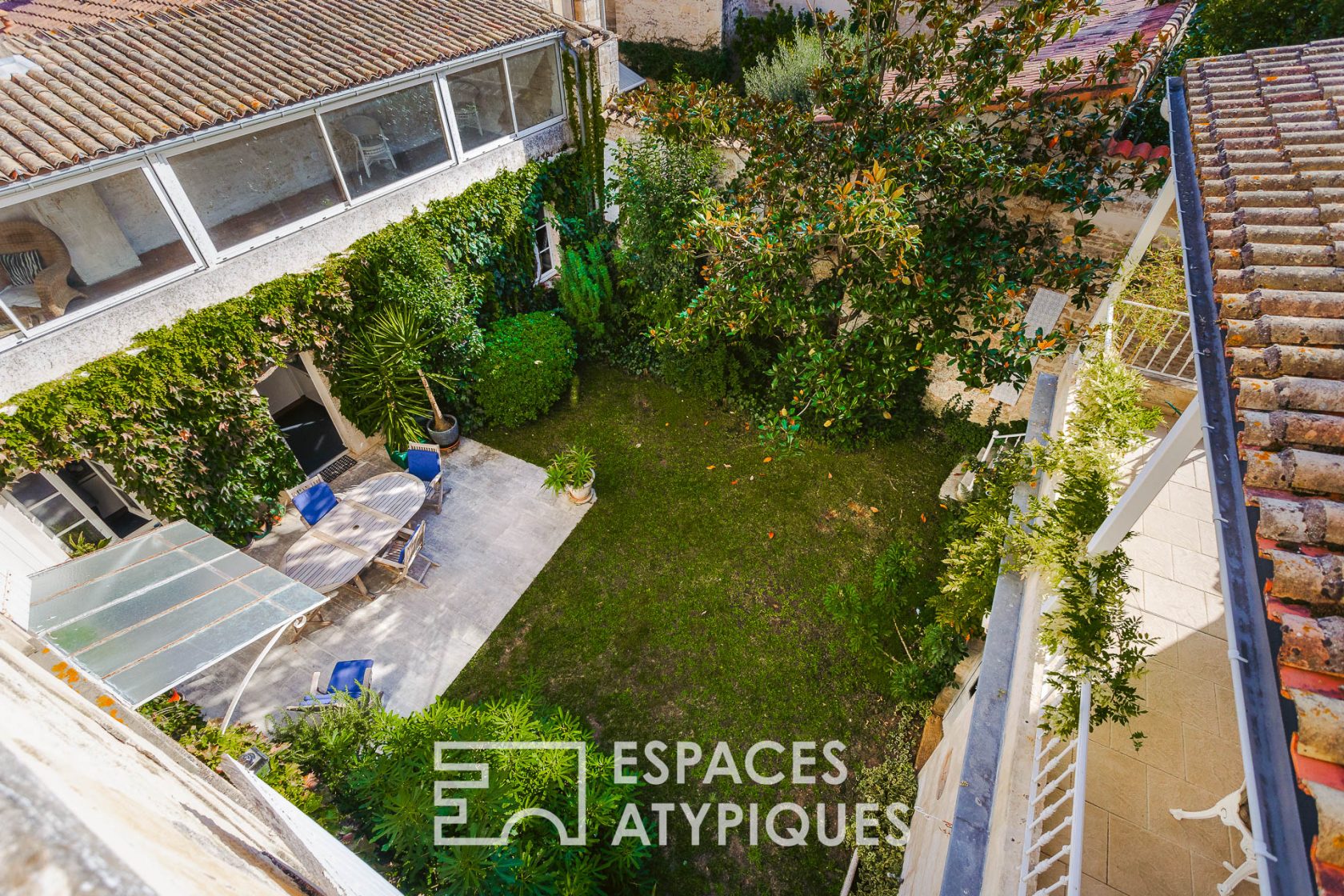 Family home around its tree-lined courtyard