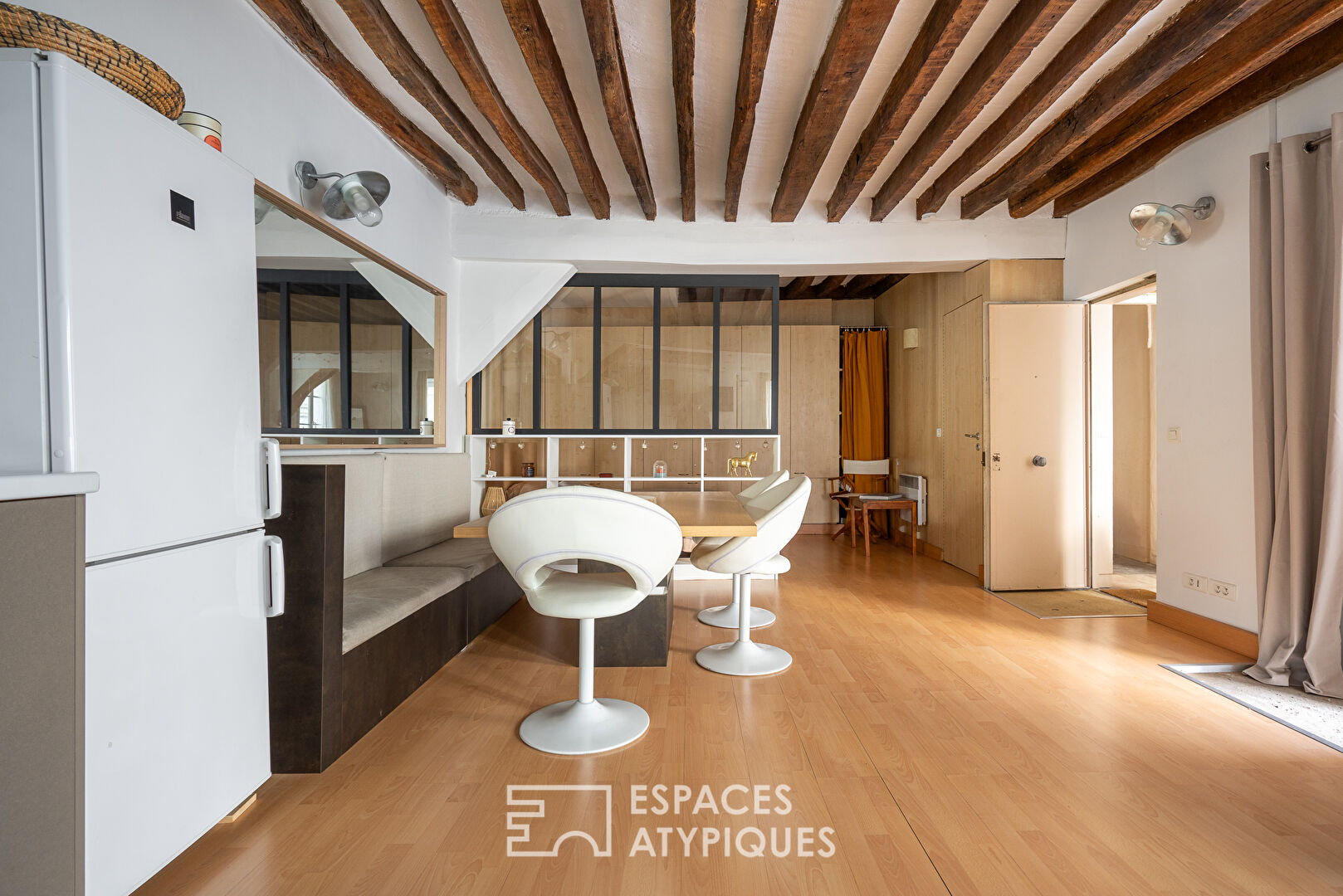 Apartment with exposed beams on paved courtyard