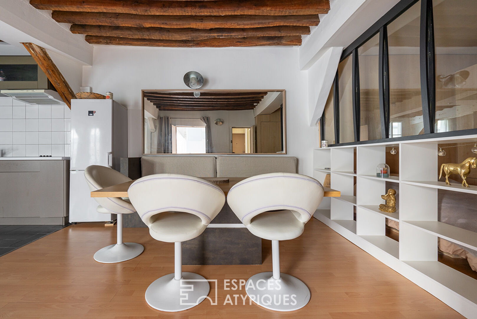 Apartment with exposed beams on paved courtyard