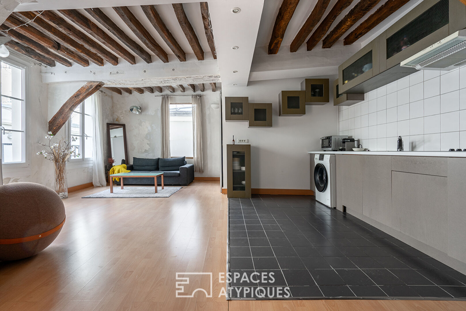 Apartment with exposed beams on paved courtyard