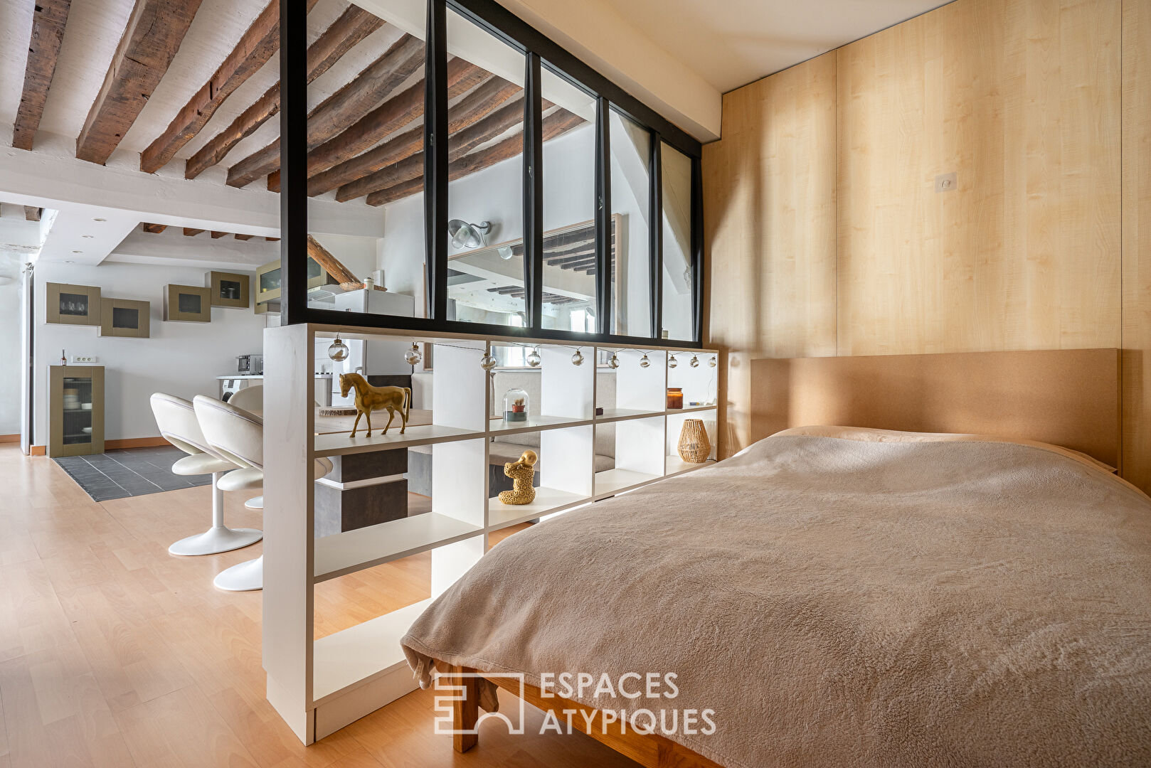 Apartment with exposed beams on paved courtyard