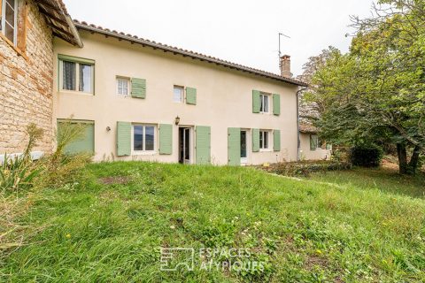 Character house in golden stones with landscaped garden